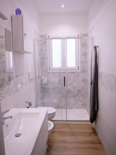 a bathroom with a shower and a toilet and a sink at Da Nonna Maria in Grottaglie