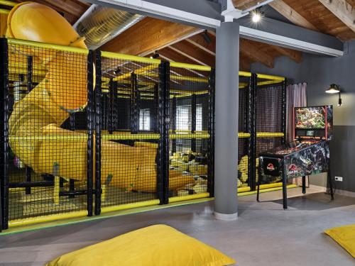 a room with yellow cages with animals in it at PLACES Obertauern by Valamar in Obertauern