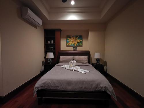 a bedroom with a bed with a towel on it at Casa del Rio Luxury Residences in Melaka