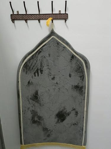 a mirror hanging on a wall at Adempuri Homestay 3 in Jitra