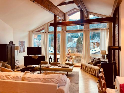 a living room with two couches and a christmas tree at Landhaus Frank in Bad Kleinkirchheim