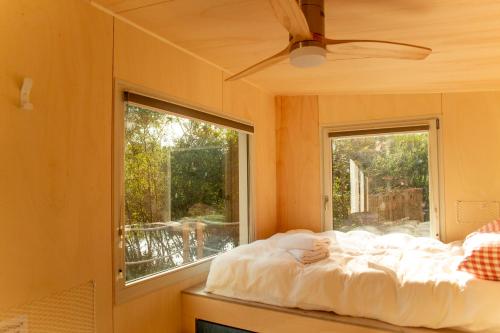 Schlafzimmer mit einem Bett vor einem Fenster in der Unterkunft Le repaire des impressionnistes in Amenucourt