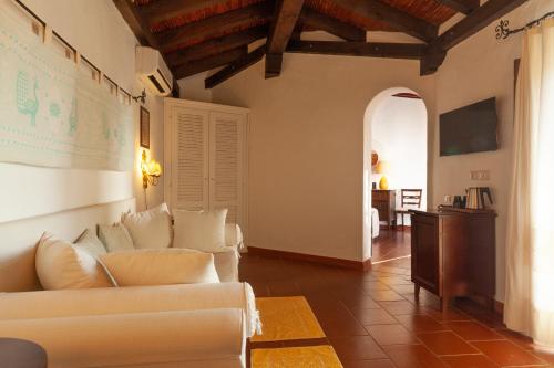 a living room with white couches and a map on the wall at Nora Club Hotel & Spa in Pula