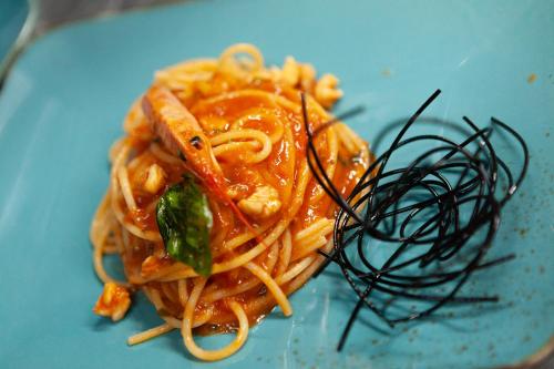 a plate of spaghetti with sauce on a blue plate at Nora Club Hotel & Spa in Pula
