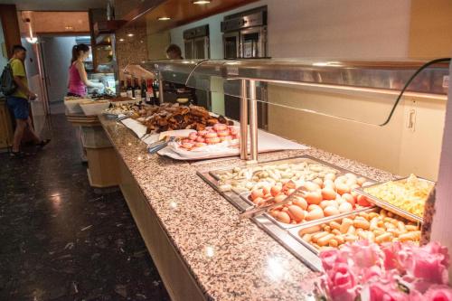 a counter filled with lots of different types of food at Hotel Amic Gala in Can Pastilla
