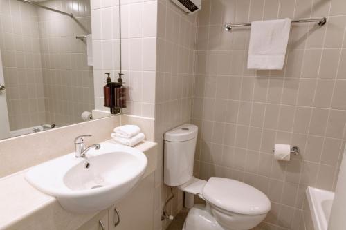 a bathroom with a white toilet and a sink at Lantern 1 Bedroom Balcony with Panoramic Alpine View in Thredbo