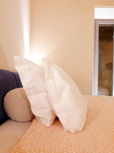 a pillow sitting on top of a couch at Hotel Aracoeli in Orta San Giulio