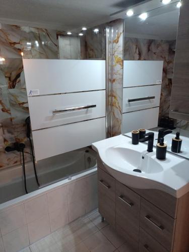a bathroom with a sink and a bath tub at home2024 in Alexandroupoli