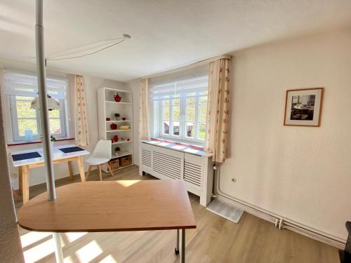 a living room with a table and a window at Ferienwohnung WACHE im HAUS GERLACH in Walkenried