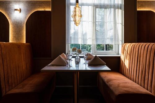 a dining room with a table and a window at Park hall Hotel & Spa Lancashire, a member of Radisson Individuals in Eccleston