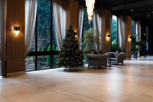 a christmas tree in the middle of a lobby at Park hall Hotel & Spa Lancashire, a member of Radisson Individuals in Eccleston