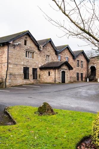 a large brick building with a driveway in front of it at Park hall Hotel & Spa Lancashire, a member of Radisson Individuals in Eccleston