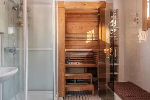 a walk in shower in a bathroom with a glass door at Villa Ojala, a lovely cottage with own beach in Kuusamo