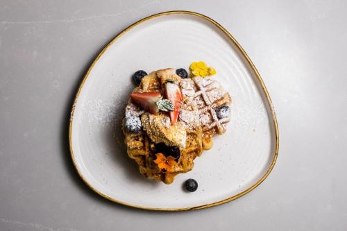 a white plate with a piece of dessert on it at Park hall Hotel & Spa Lancashire, a member of Radisson Individuals in Eccleston