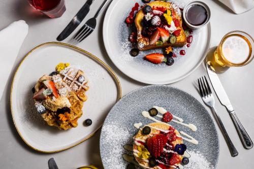 three plates of breakfast food on a table at Park hall Hotel & Spa Lancashire, a member of Radisson Individuals in Eccleston
