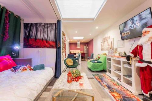 a living room with a santa claus in a room at Casa Inca Calais - Appart Amazonas - Parking Free, Station in Calais