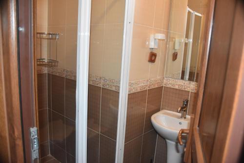 a bathroom with a shower and a toilet and a sink at The Han in Istanbul