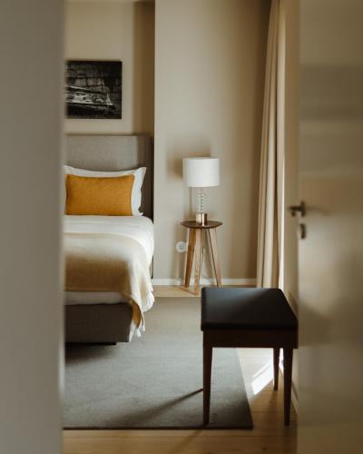 a bedroom with a bed and a table with a lamp at 108MM House in Porto
