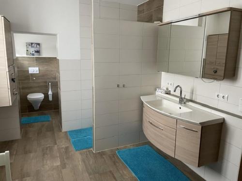 a bathroom with a sink and a toilet at Haus Betty in Rattelsdorf