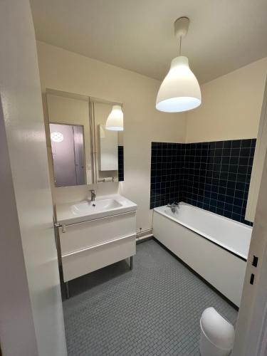 une salle de bain avec un lavabo, une baignoire et des toilettes dans l'établissement Appartement lumineux 2 pièces Paris – idéal famille, à Paris