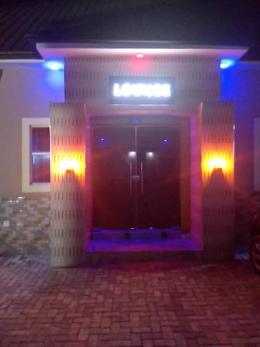 a building with a door with purple lights on it at CHARLES GROOVE HOTEL 