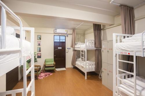 a room with a bunch of bunk beds at Allred Hostel Chiangmai in Chiang Mai