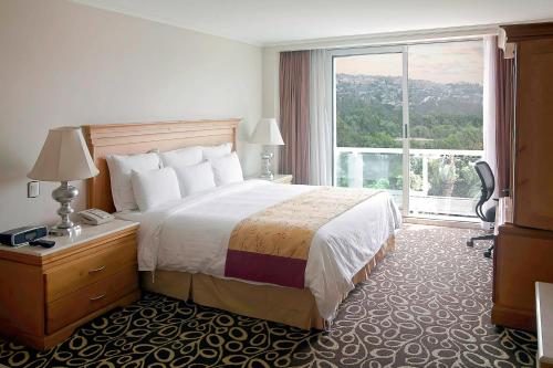 a hotel room with a bed and a large window at Marriott Tijuana Hotel in Tijuana