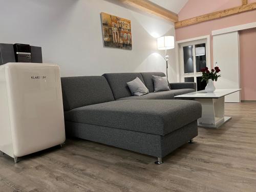 a living room with a couch and a table at Ferienwohnung Schwein gehabt in Allna