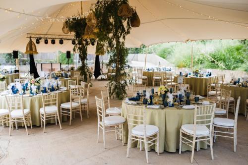 a wedding reception with tables and chairs in a tent at Balcón de Válor in Válor