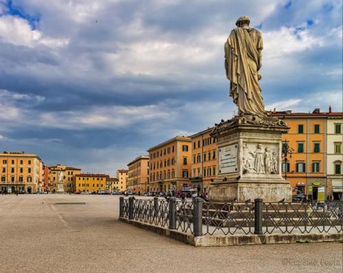 a statue in the middle of a city with buildings at B&B centro di livorno in Livorno