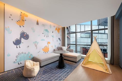 a childrens room with a dinosaur wall mural at Four Points by Sheraton Chongqing, Yongchuan in Yongchuan