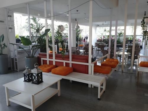 a white bench with orange pillows in a restaurant at The Embassy Suites in Hyderabad