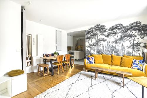 salon z żółtą kanapą i stołem w obiekcie Luxury top floor duplex near Le Marais w Paryżu