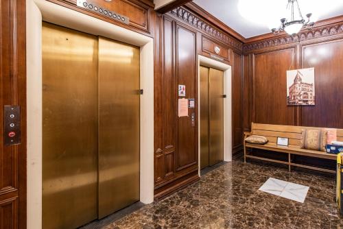 a hallway with a elevator in a building at Luxe Louisville Condo~King BR~Near YUM Center in Louisville