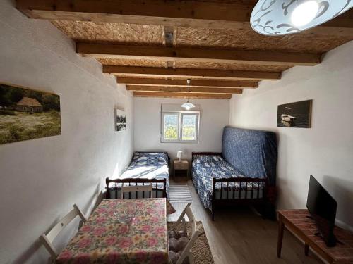 a small living room with a couch and a table at Apartment Marojevic Lipovo in Kolašin