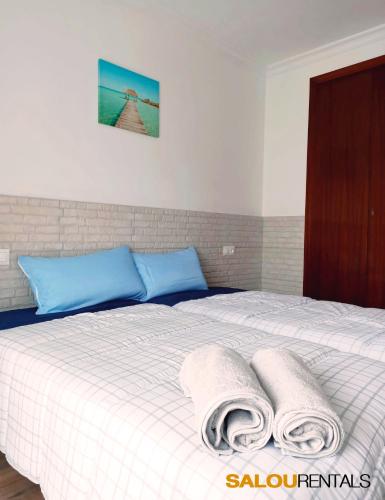 a bedroom with a bed with towels on it at Blue Sky Montblanc - Swimming Pool & AC in Salou
