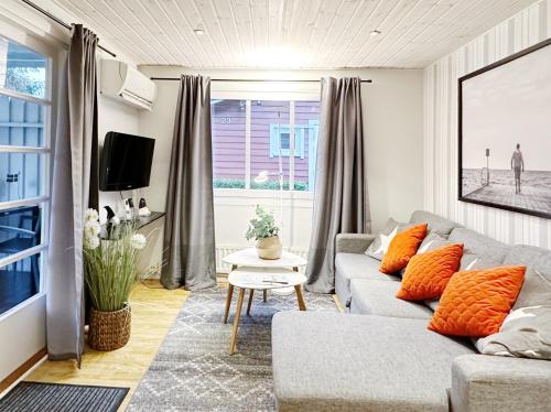 a living room with a couch and a window at Ystad Holiday Houses in Ystad