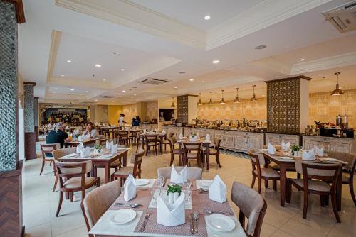 a restaurant with tables and chairs and a bar at Ajit Bhawan - A Palace Resort in Jodhpur