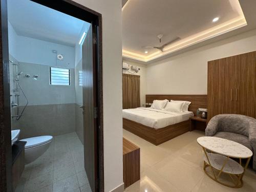 a hotel room with a bed and a bathroom at SRI KRISHNA RESIDENCY in Tiruchchirāppalli