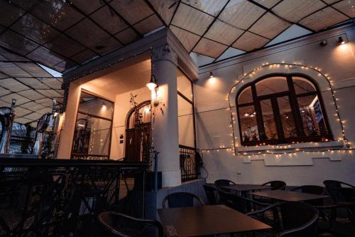 a dining room with tables and chairs and lights at Casa Del Sole in Alba Iulia