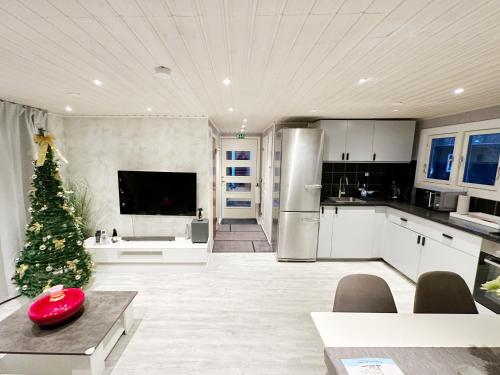 a kitchen with a christmas tree in the middle of it at Ystad Holiday Houses in Ystad