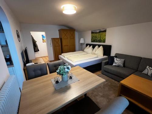 a living room with a bed and a couch and a table at Premium Mara in Sankt Johann im Pongau