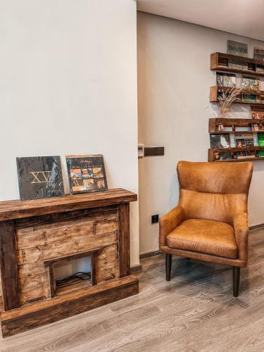 a chair in a room with a fireplace at Luxury Pentstudio Westlake - Tay Ho, Ha Noi in Hanoi