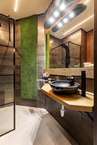 a bathroom with a sink and a mirror at Friday’s apartman in Debrecen