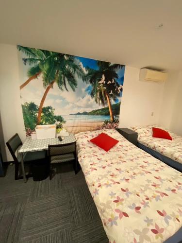 a bedroom with two beds and a desk with a mural at MR TOMO FUJI in Fuji