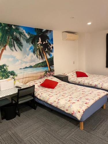two beds in a room with a painting on the wall at MR TOMO FUJI in Fuji