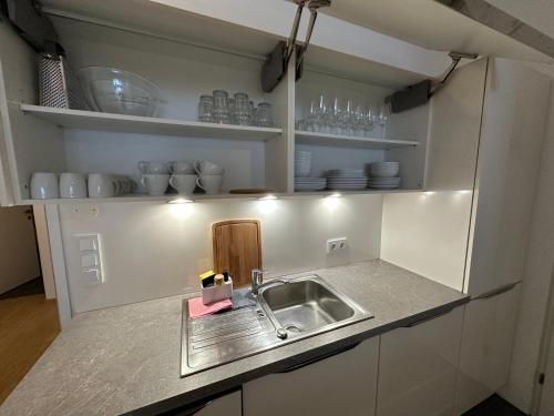 a kitchen with a sink and a counter top at Geräumiges modernes Apartment 1-6 Personen in Imst