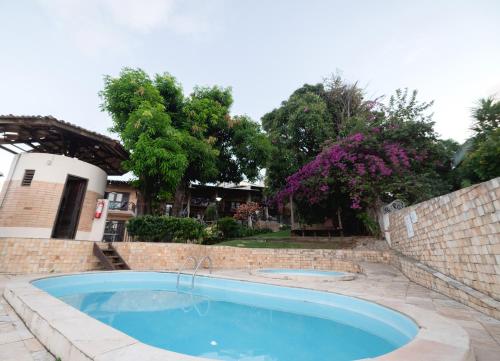 a swimming pool in a brick wall next to a brickickedicked at Cobertura exclusiva em ponta negra com vista para o mar in Natal