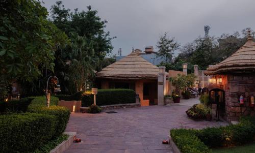 a house with a tile roof and a courtyard at Ajit Bhawan - A Palace Resort in Jodhpur