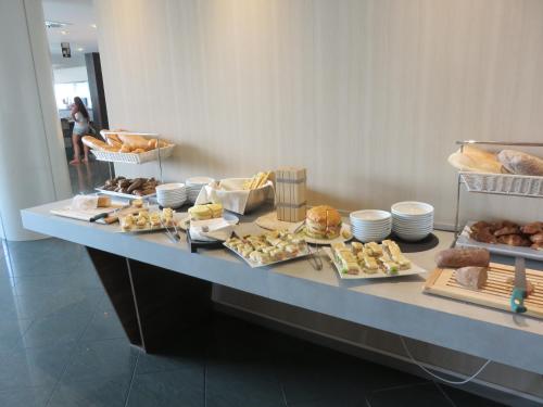 a buffet line with different types of bread and pastries at Waldorf Palace Hotel in Cattolica